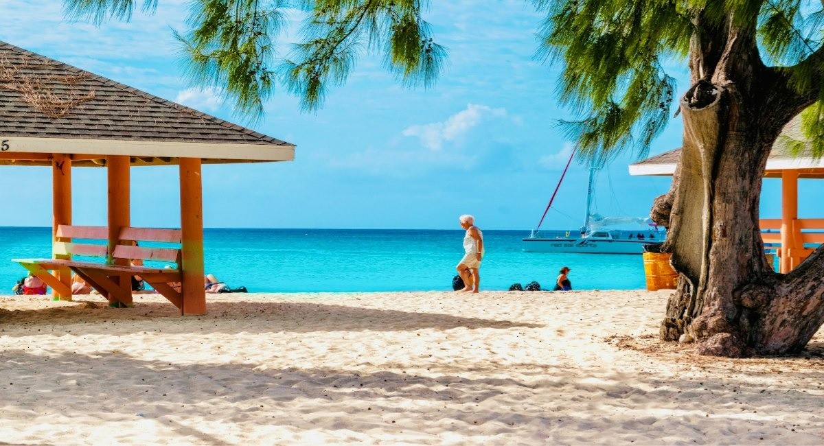 Seven Mile Public Beach Grand Cayman with beach gazebos and catamaran