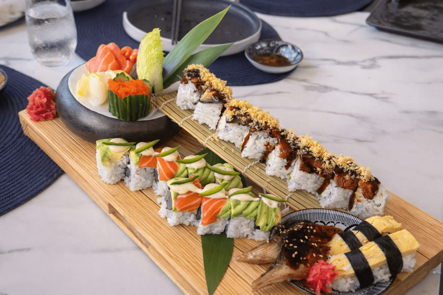 Sushi rolls on a wooden board at Kojima Izakaya Grand Cayman
